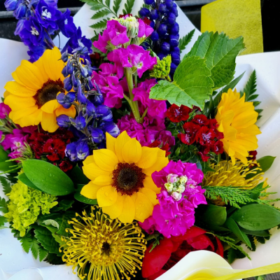 Bold and Beautiful - A vibrant bouquet with a striking mix of red, purple, and green flowers, perfect for adding a pop of color to any room or occasion.